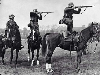 German soldiers take aim from the backs of horses, mid-1930