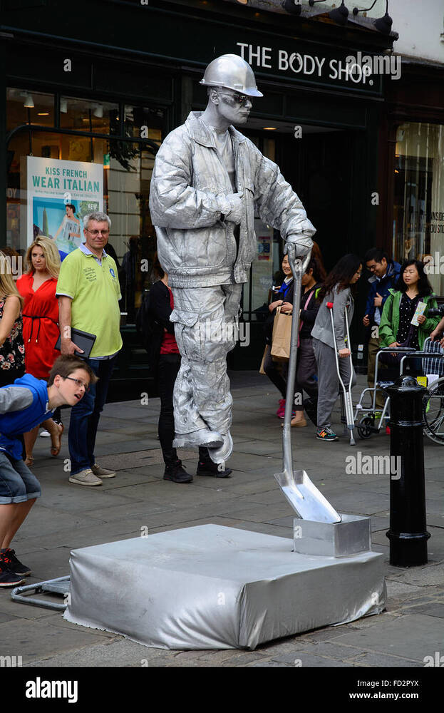 boy-investigates-a-floating-silver-living-statue-covent-garden-london-FD2PYX