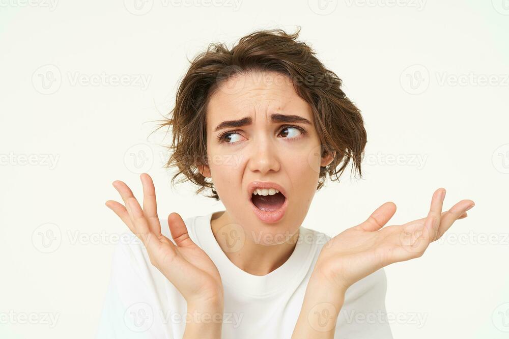 portrait-of-confused-puzzled-young-woman-gasping-looking-disappointed-and-frustrated-shrugging-shoulders-posing-over-white-background-photo